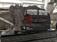 a beautifully sculpted headstone of an angel standing between two polished hearts.,and Absolute Black and Angel Headstone-017